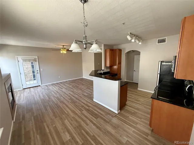 a view of a kitchen counter space a sink and wooden floor