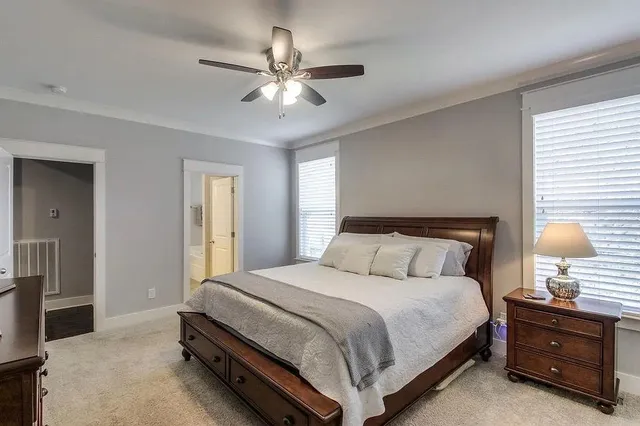 a bedroom with a bed and a lamp