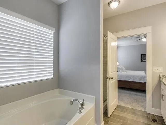a en suite bathroom with a tub and shower