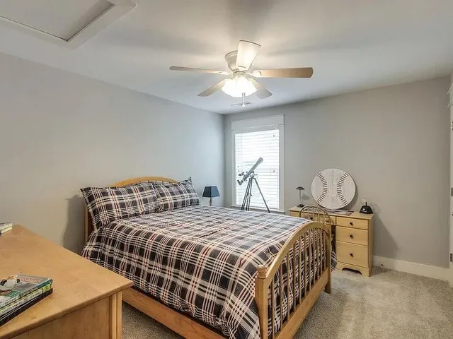 a bedroom with a bed and window