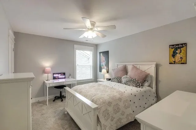 a bedroom with a bed and a table