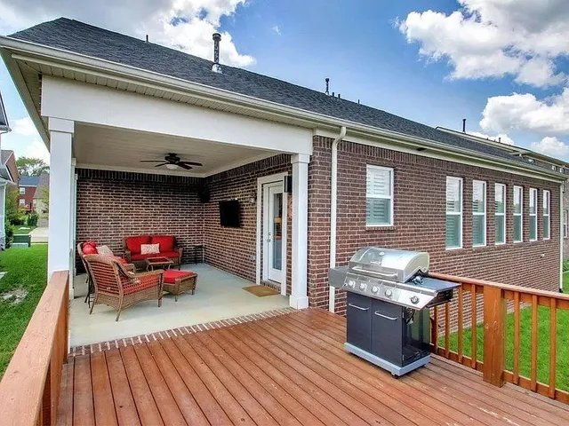 a balcony with furniture and a large window