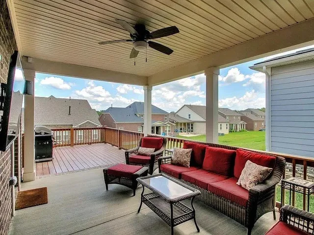 a balcony with furniture and a flat screen tv