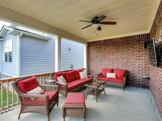 a view of a backyard with sitting area