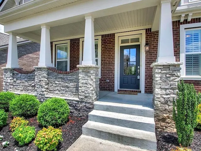 a front view of a house with a garden