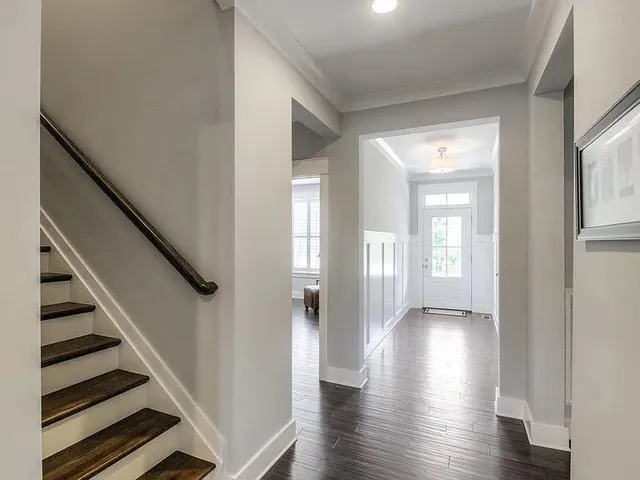 a view of an entryway with wooden floor and stairs
