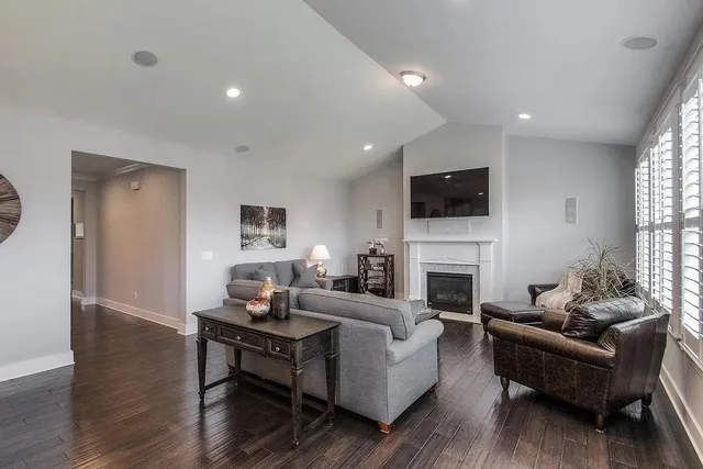a living room with furniture a fireplace and a flat screen tv