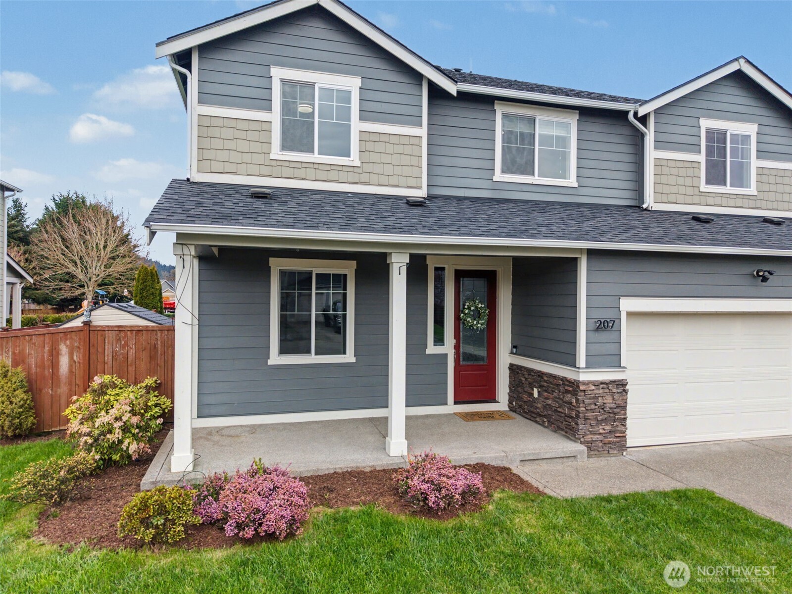 207 Fielding Street Northeast Orting, WA 98360 - Photo 2 of 37 a house view with a garden space