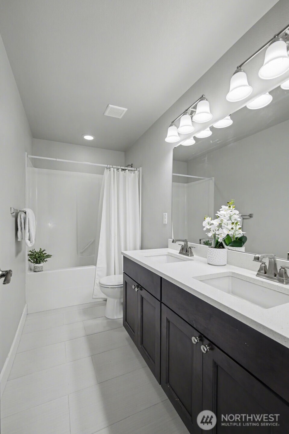 207 Fielding Street Northeast Orting, WA 98360 - Photo 23 of 37 a spacious bathroom with a double vanity sink and a mirror