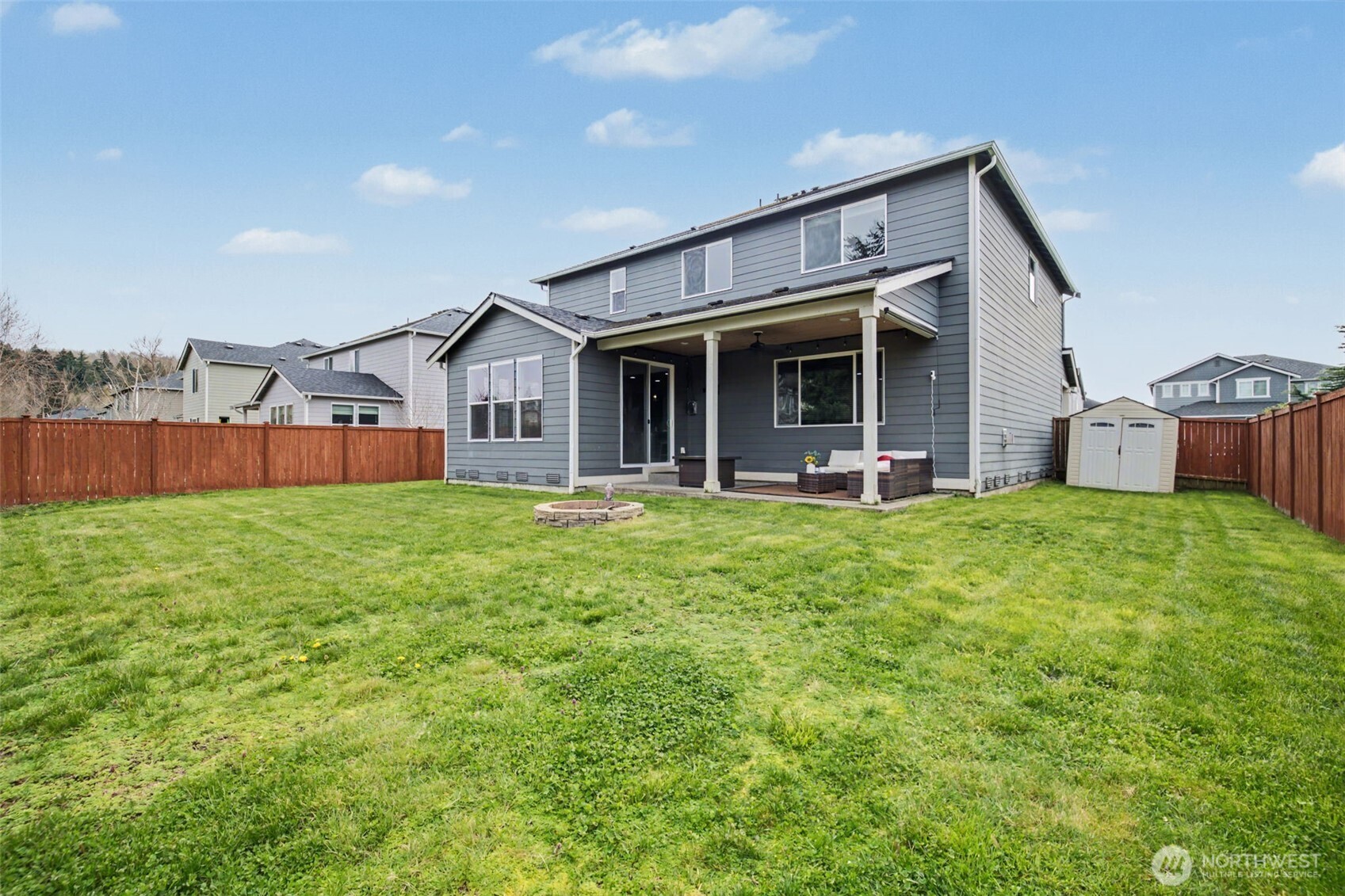207 Fielding Street Northeast Orting, WA 98360 - Photo 29 of 37 a view of a house with a yard and sitting area