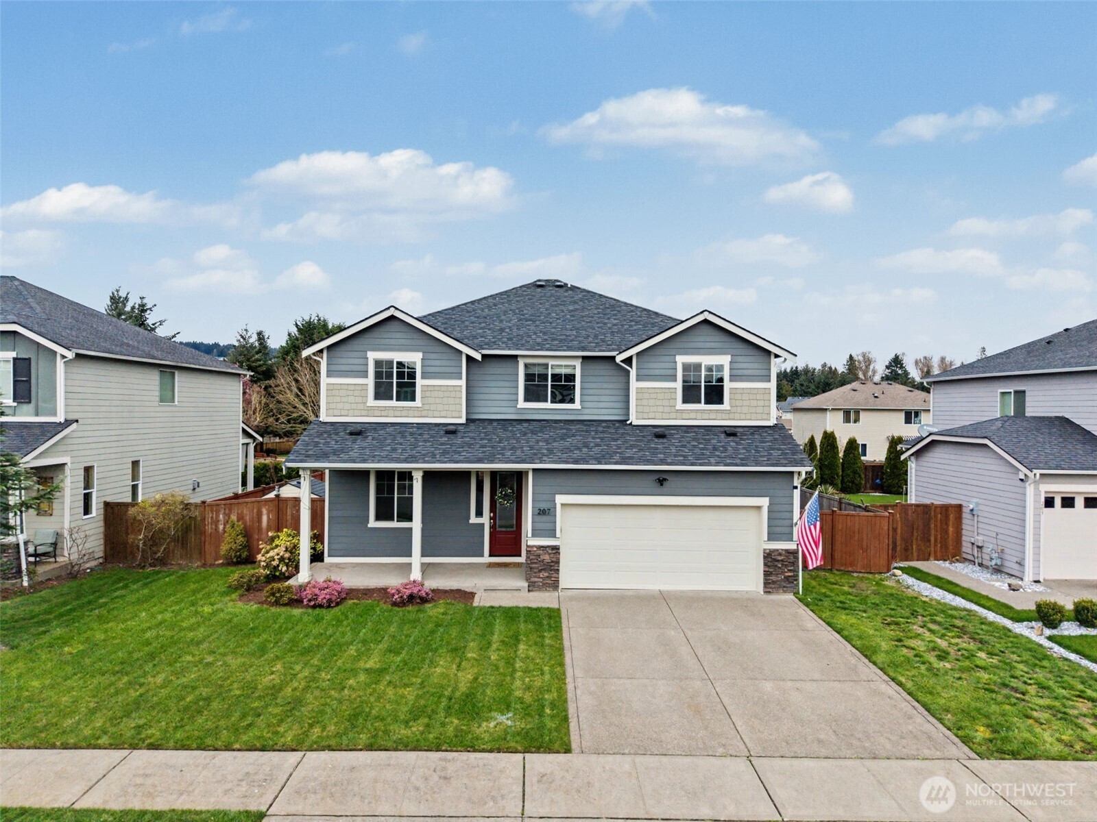 207 Fielding Street Northeast Orting, WA 98360 - Photo 31 of 37 a front view of house with yard and green space