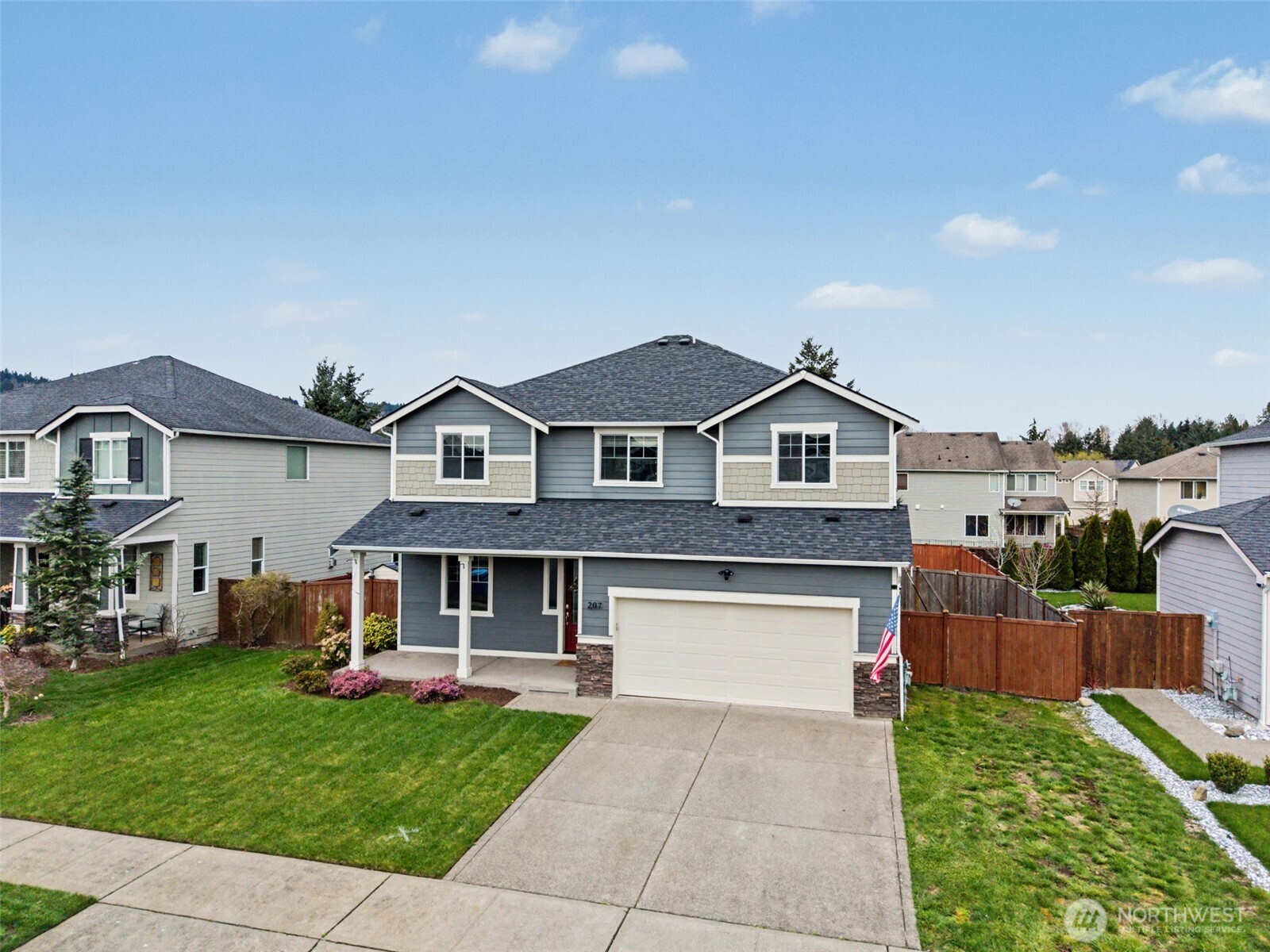 207 Fielding Street Northeast Orting, WA 98360 - Photo 33 of 37 a front view of a house with a yard