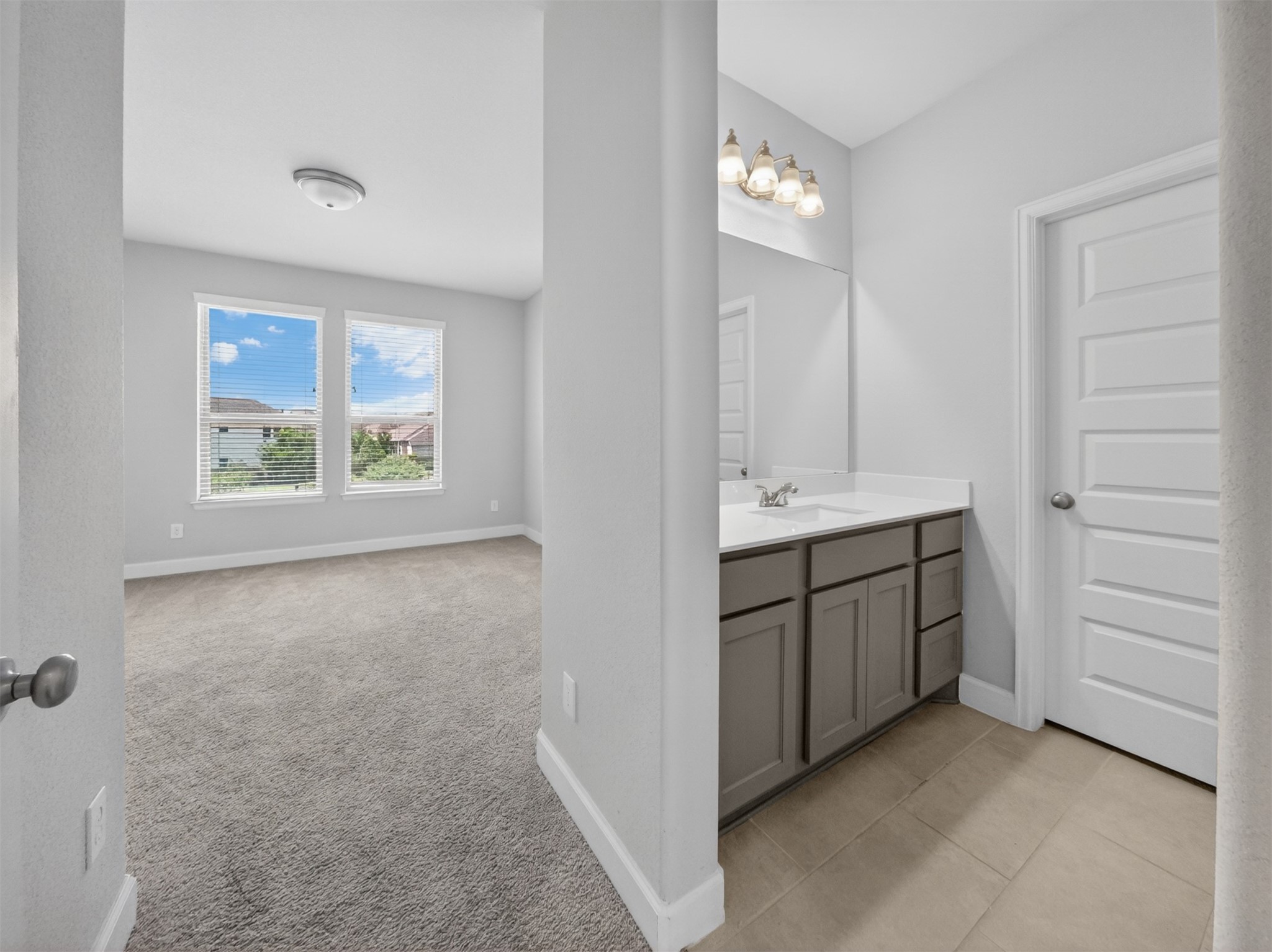 4343 Martin Ridge Drive Manvel, TX 77578 - Photo 30 of 50 a bathroom with a double vanity sink a window and a mirror
