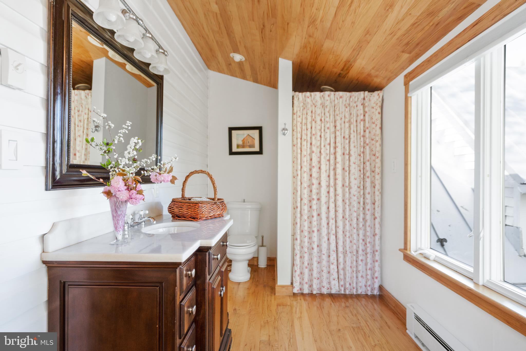 873 Hawlin Road Woodville, VA 22749 - Photo 27 of 45 a view of a bath tub sitting in a bathroom next to a window
