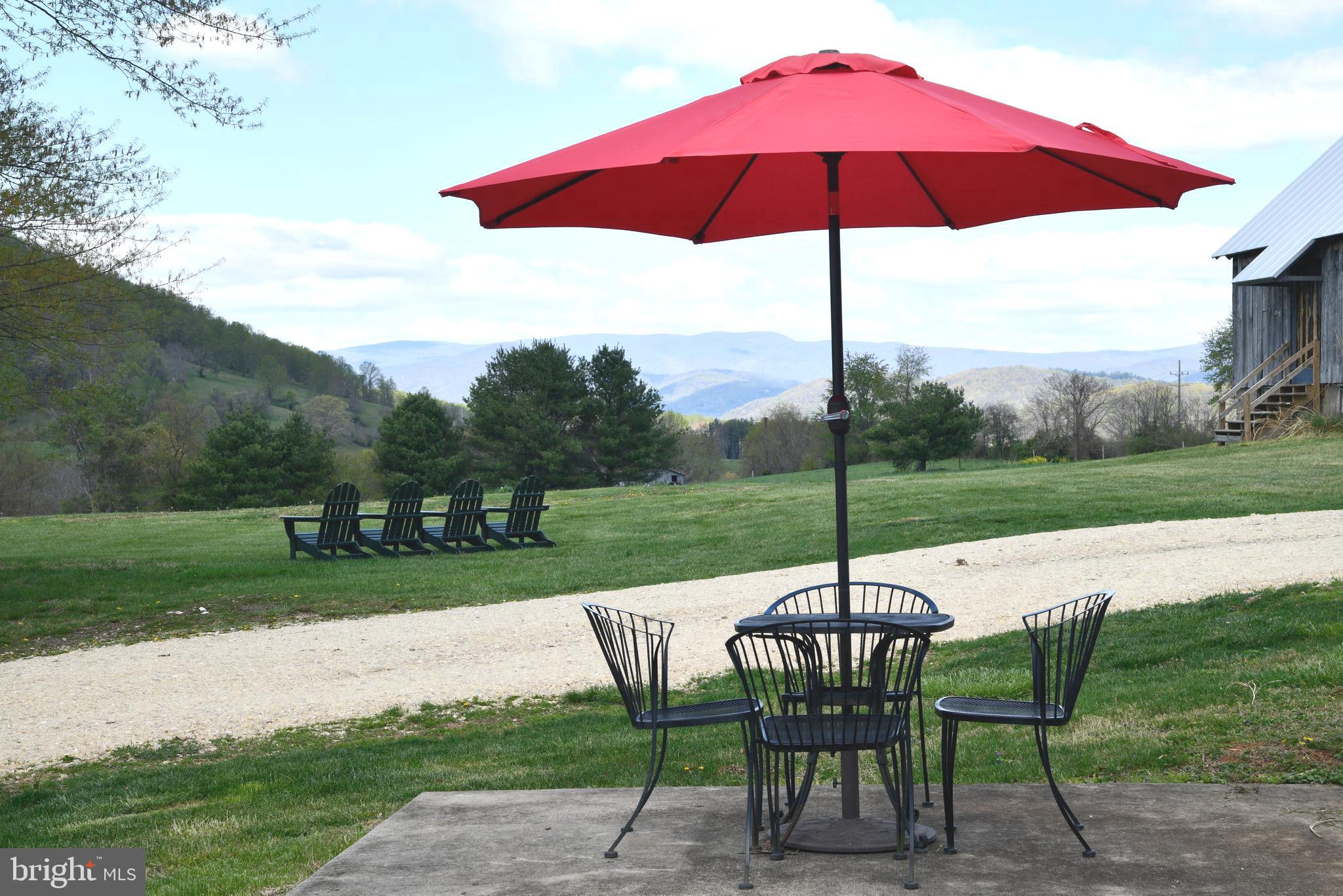 873 Hawlin Road Woodville, VA 22749 - Photo 36 of 45 a view of a table and chairs under an umbrella