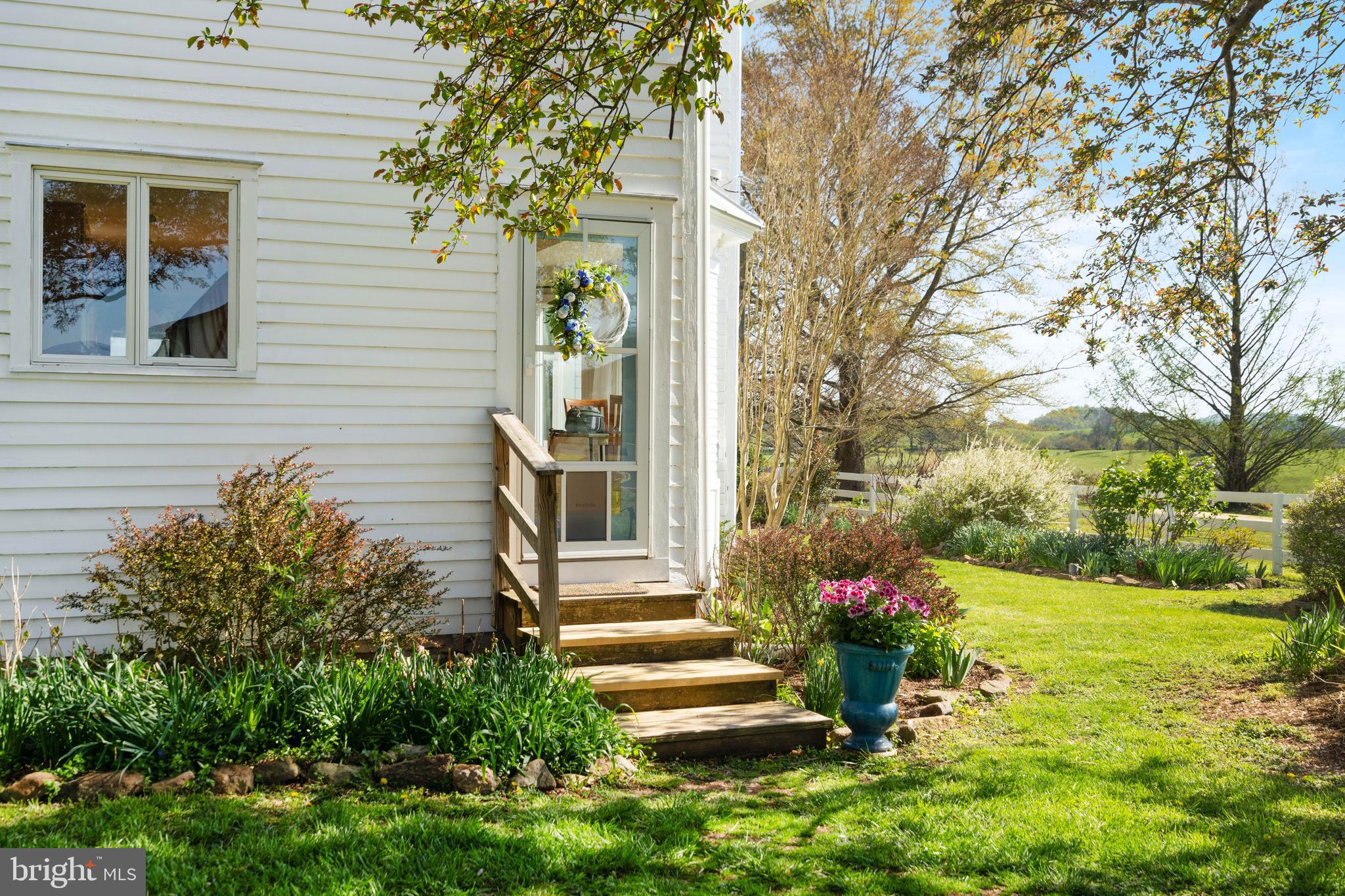 873 Hawlin Road Woodville, VA 22749 - Photo 7 of 45 a front view of a house with a yard and potted plants