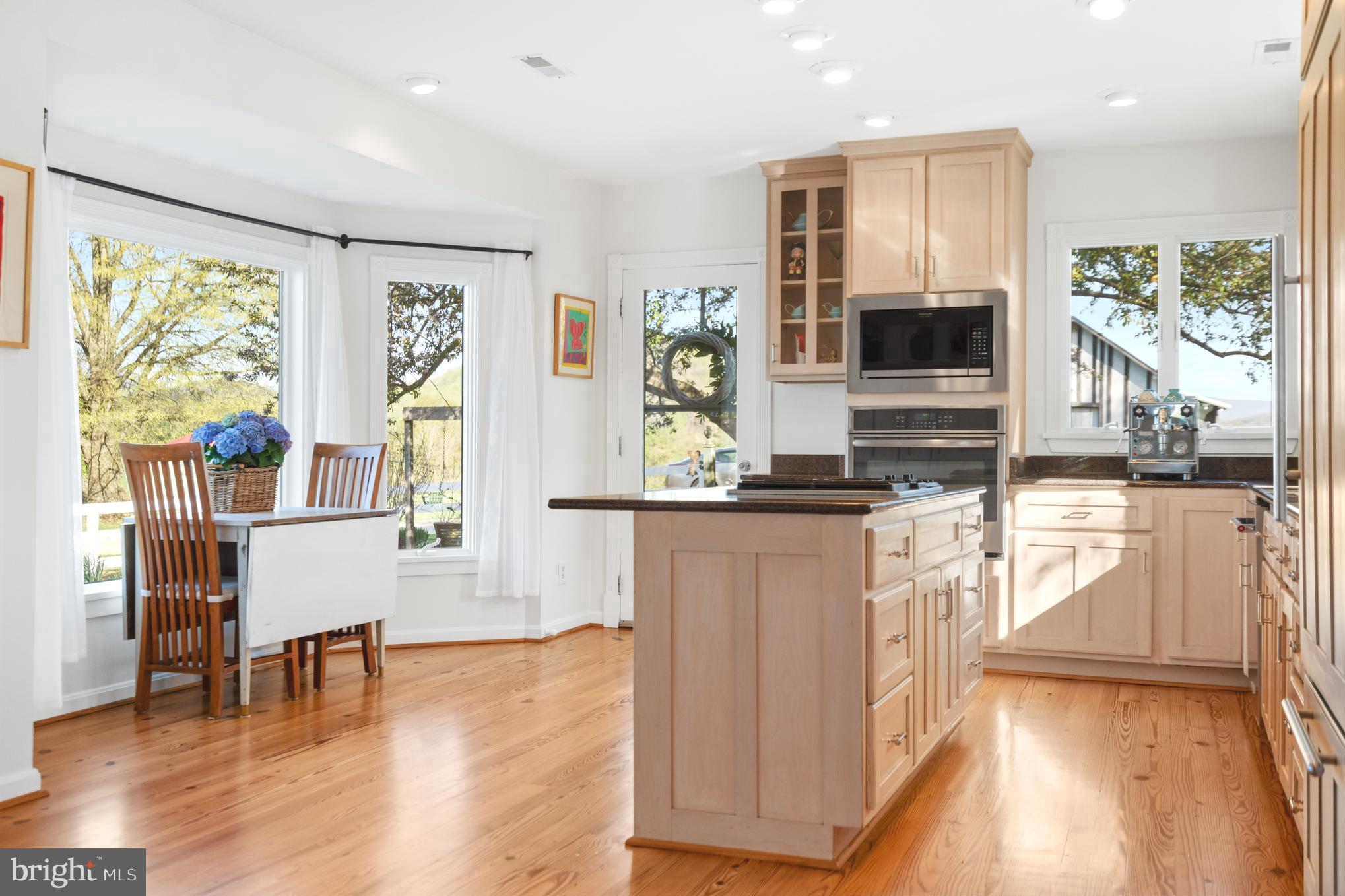 873 Hawlin Road Woodville, VA 22749 - Photo 8 of 45 a open kitchen with stainless steel appliances granite countertop a stove and a refrigerator