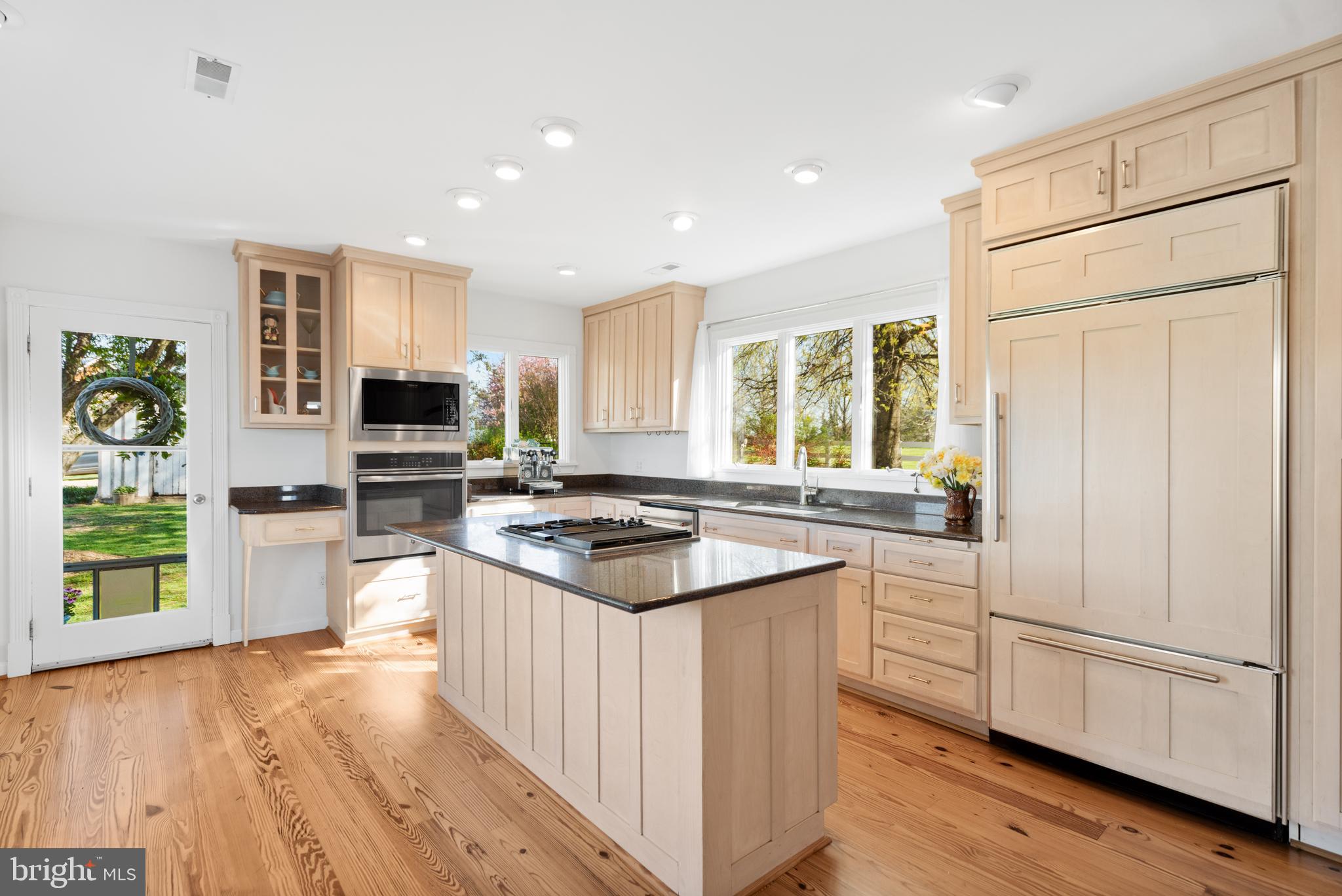 873 Hawlin Road Woodville, VA 22749 - Photo 9 of 45 a kitchen with stainless steel appliances a stove top oven a refrigerator a sink and dishwasher with wooden floor