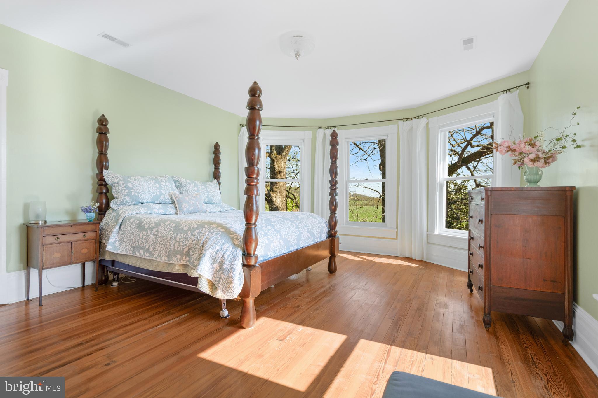 873 Hawlin Road Woodville, VA 22749 - Photo 10 of 45 a bedroom with a bed and wooden floor