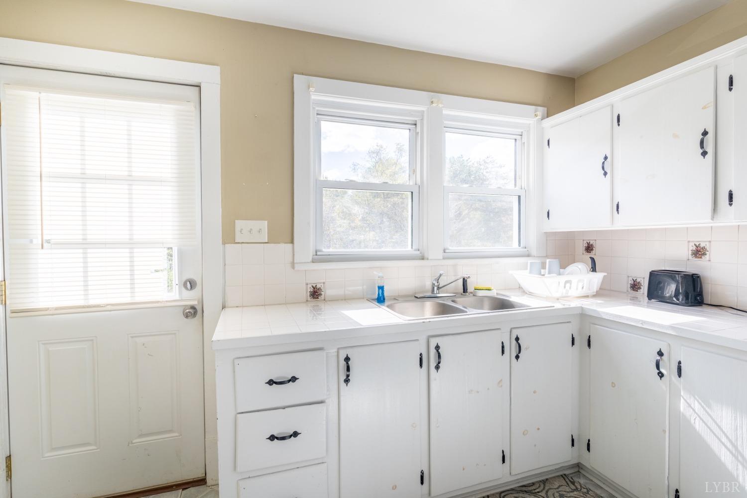 3676 Depot Road Rustburg, VA 24588 - Photo 11 of 37 a view of cabinets a sink and dishwasher with window
