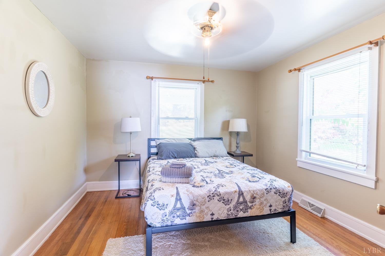 3676 Depot Road Rustburg, VA 24588 - Photo 14 of 37 a bedroom with a bed and wooden floor
