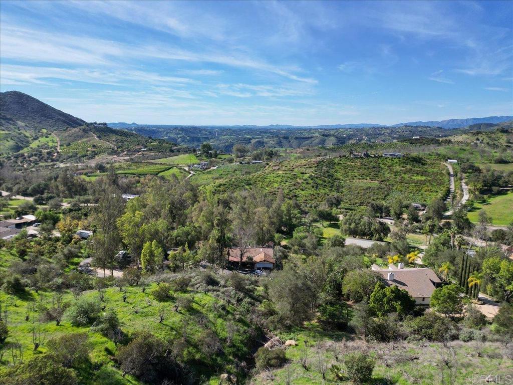 823 Rice Canyon Road Fallbrook, CA 92028 - Photo 1 of 30 an aerial view of a city with lots of residential buildings and mountain view in back