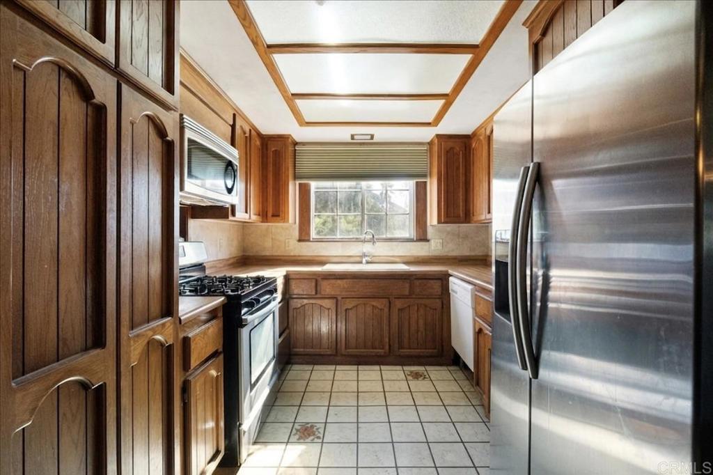 823 Rice Canyon Road Fallbrook, CA 92028 - Photo 13 of 30 a kitchen with stainless steel appliances granite countertop a refrigerator and a sink