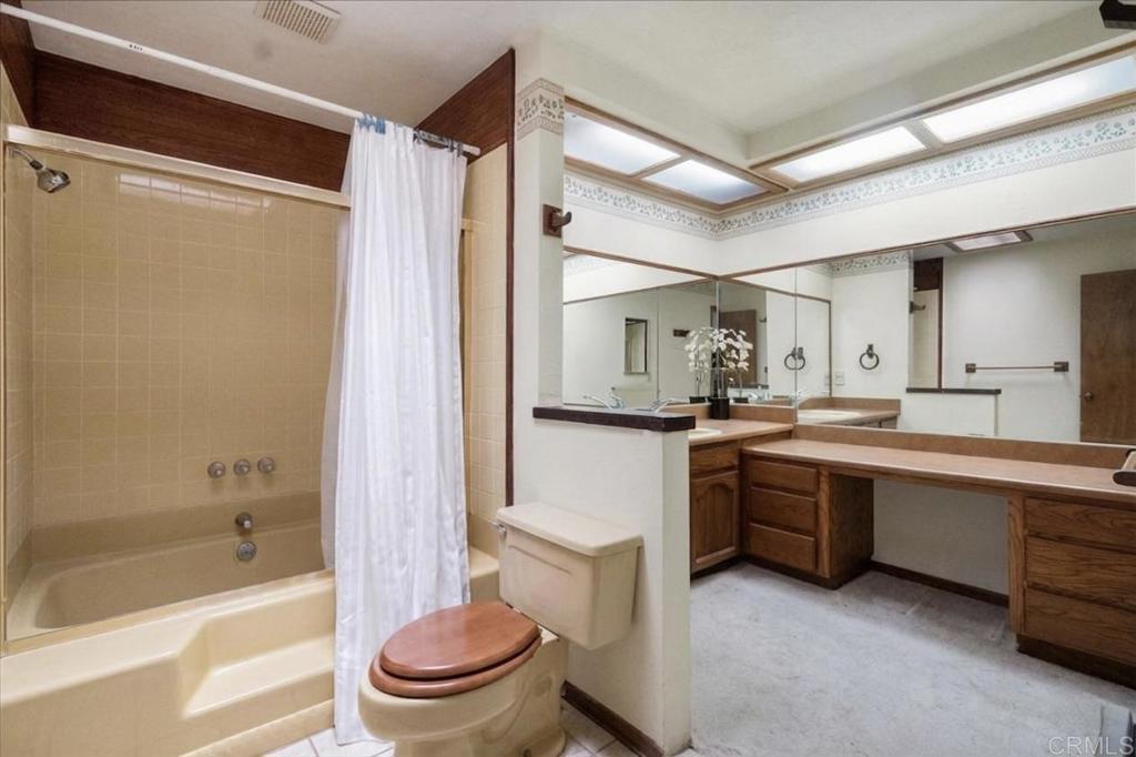 823 Rice Canyon Road Fallbrook, CA 92028 - Photo 15 of 30 a bathroom with a bathtub shower sink vanity mirror and toilet