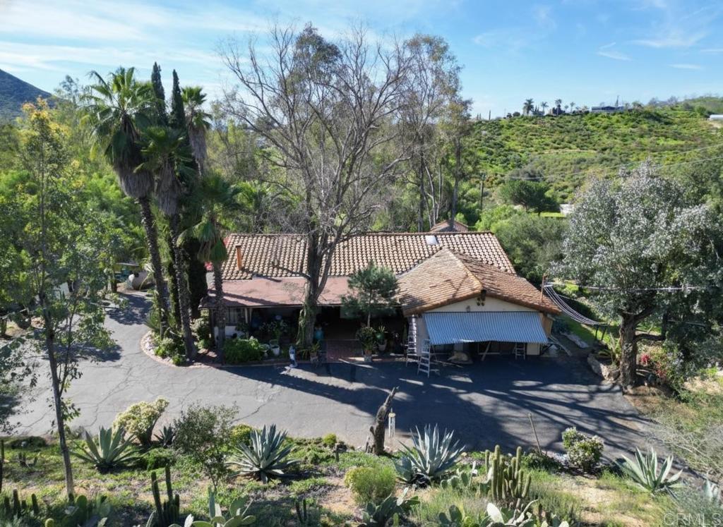 823 Rice Canyon Road Fallbrook, CA 92028 - Photo 19 of 30 a front view of a house with a yard basket ball court and outdoor seating