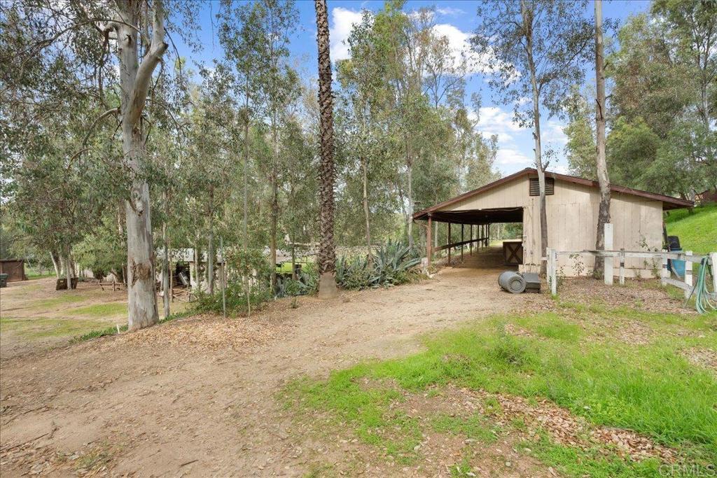 823 Rice Canyon Road Fallbrook, CA 92028 - Photo 21 of 30 a view of a house with backyard and trees