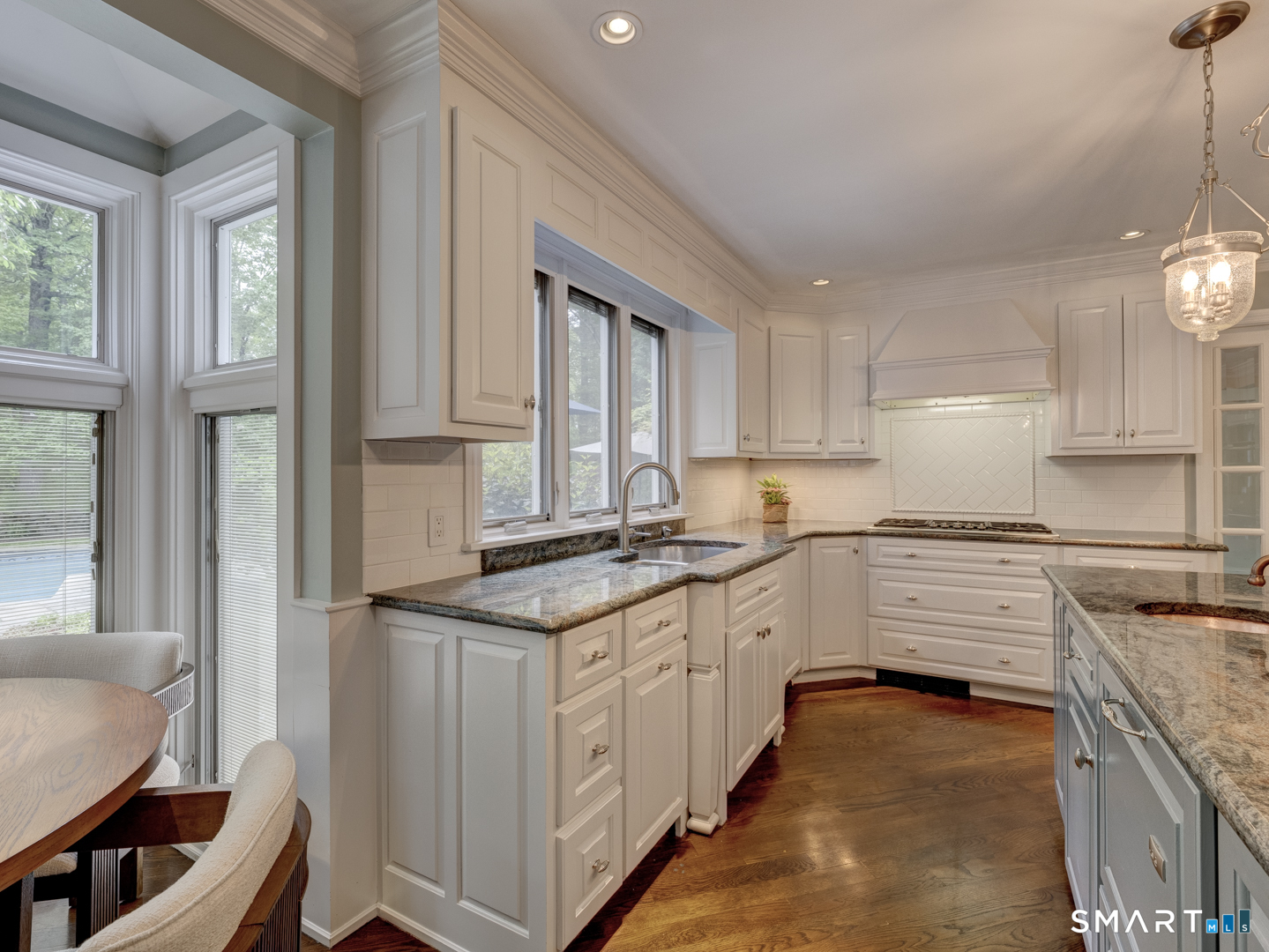 78 Windtree Street Torrington, CT 06790 - Photo 17 of 40 a kitchen with granite countertop white cabinets and white appliances