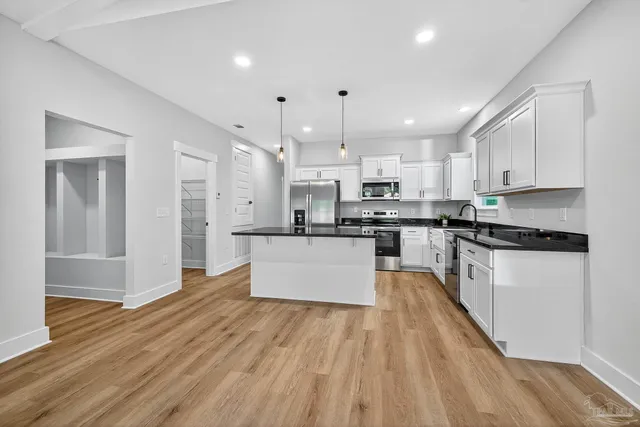 a kitchen with sink cabinets and wooden floor