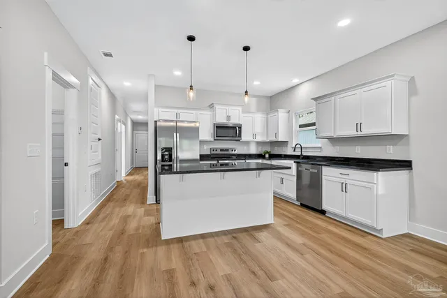 a large kitchen with stainless steel appliances lots of counter space