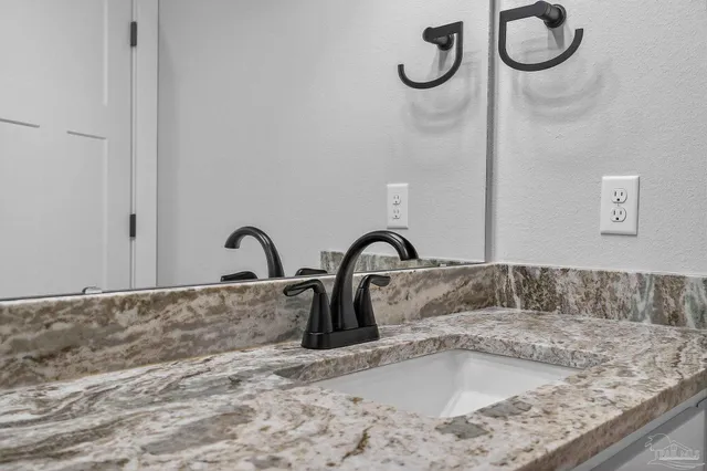 a spacious bathroom with a double vanity sink and mirror