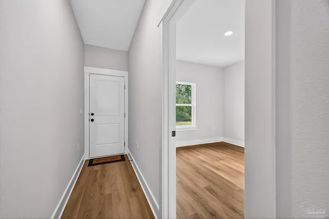 a view of a room with wooden floor