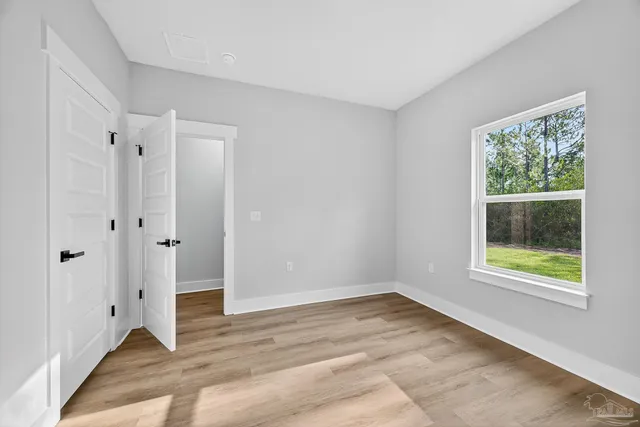 wooden floor in an empty room with a window