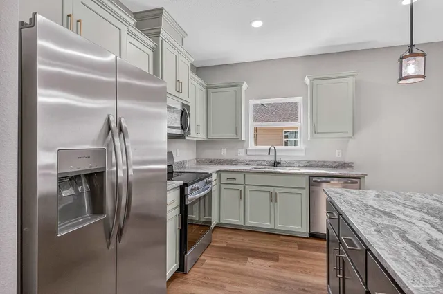 a kitchen with a sink stove and refrigerator