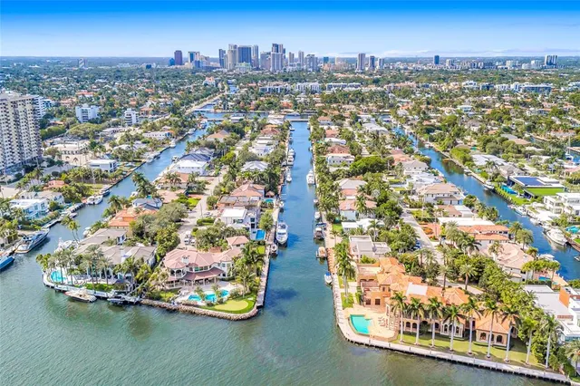 an aerial view of a city with lots of residential buildings ocean and mountain view