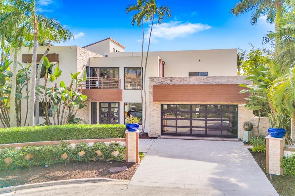 2626 Castilla Isle Fort Lauderdale, FL 33301 - Photo 5 of 18 a front view of a house with a garden and plants