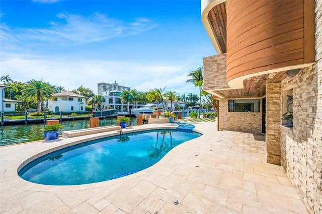 a swimming pool with outdoor seating and yard