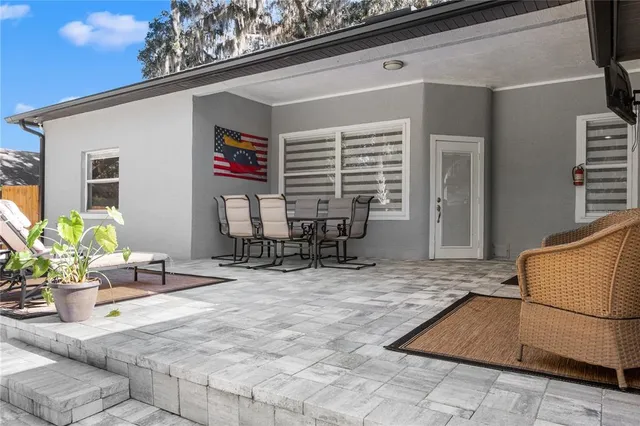 a building outdoor space with patio furniture and potted plants