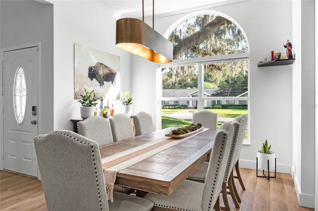 a dining room with furniture a rug and a chandelier