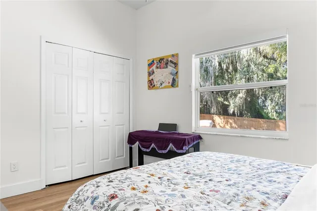 a bedroom with a bed and a window