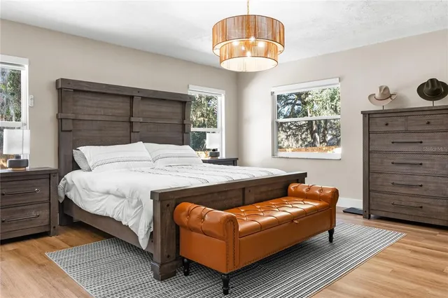 a spacious bedroom with a bed and a dresser