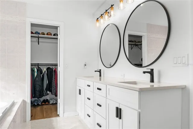 a bathroom with mirror and sink