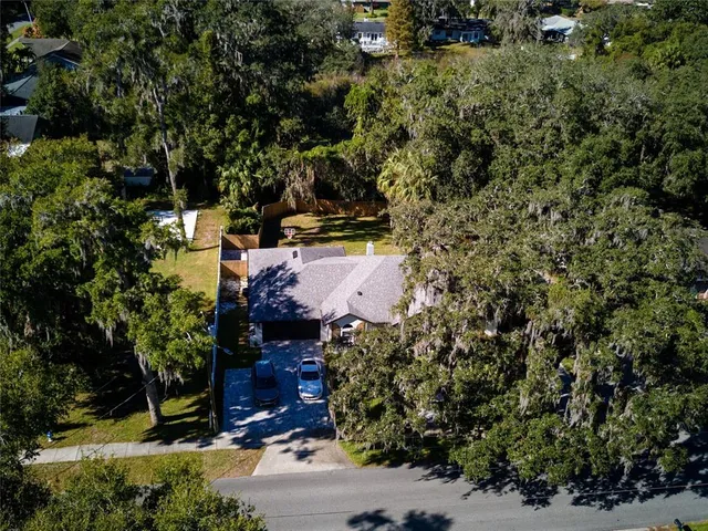 an aerial view of a house with a yard