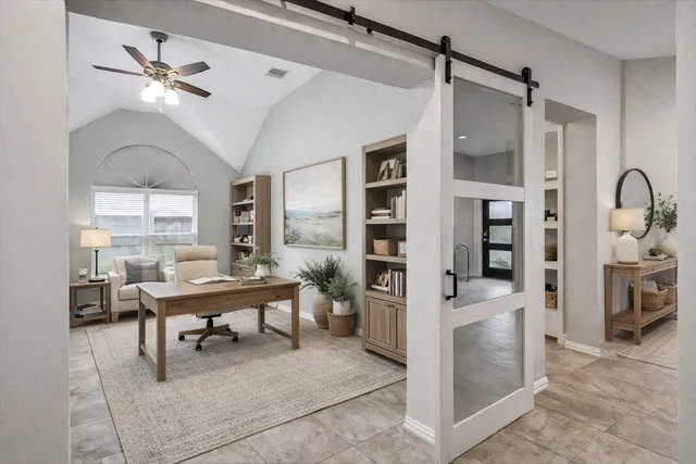 a work room with stainless steel appliances kitchen island granite countertop furniture and a view of living room