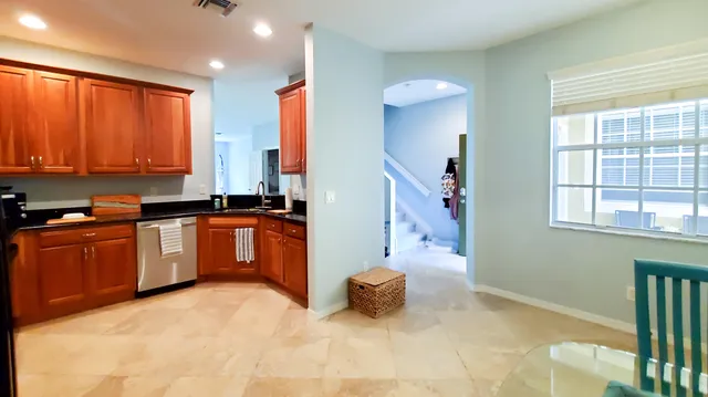 a kitchen with granite countertop a stove a sink and a microwave