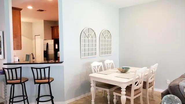 a view of a dining room with furniture and a window