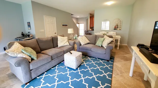 a living room with furniture and a rug